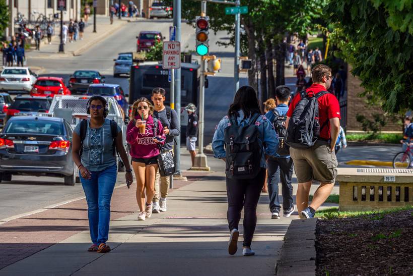Students walking along Johnson Street on the University of Wisconsin-Madison campus